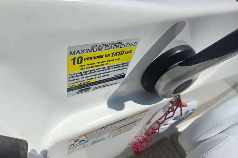 Slide: The Image of 2013 Hurricane SunDeck Sport 188 OB capacity label, showing 10-person or 1410 lbs limit. - 13