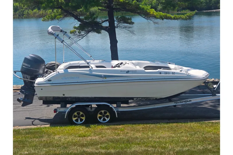 The Image of 2013 Hurricane SunDeck Sport 188 OB boat on trailer by a lake. - 0