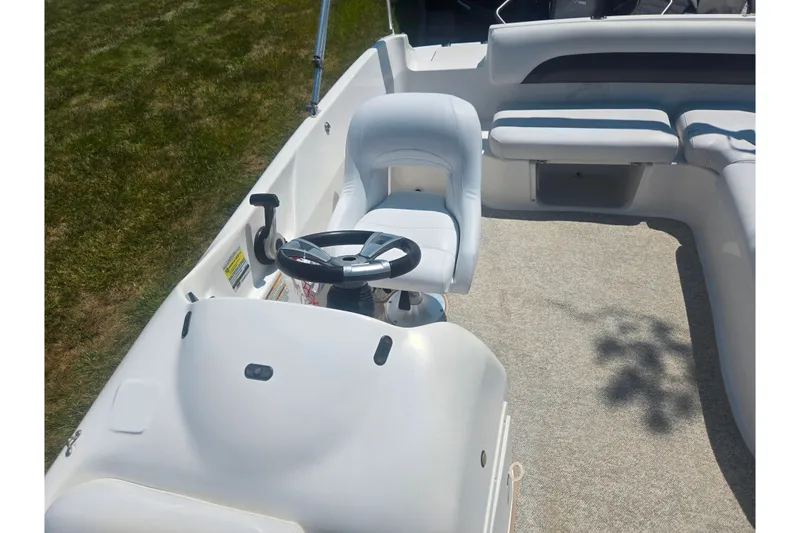 Slide: The Image of 2013 Hurricane SunDeck Sport 188 OB boat interior with steering wheel and seating. - 12