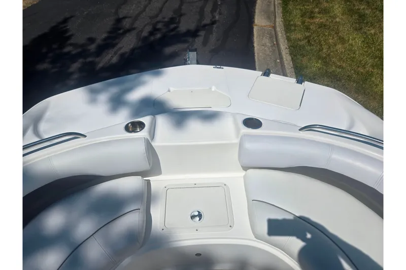 Slide: The Image of 2013 Hurricane SunDeck Sport 188 OB boat interior with white seating and cup holders. - 22