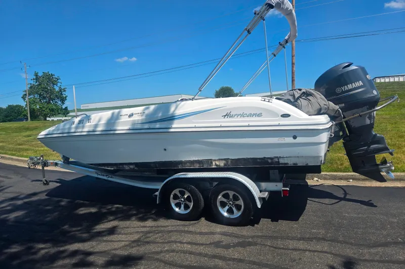 Slide: The Image of 2013 Hurricane SunDeck Sport 188 OB boat on trailer with Yamaha outboard motor. - 4