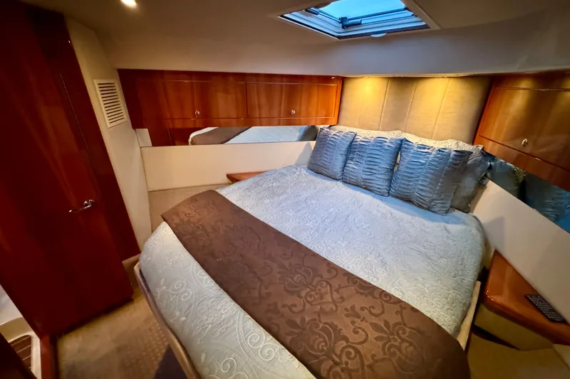 Slide: The Image of Luxurious bedroom interior of 2009 Riviera 45 Open Flybridge yacht with elegant bedding. - 51