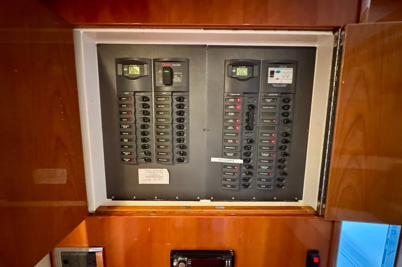 Slide: The Image of Electrical panel inside 2009 Riviera 45 Open Flybridge yacht, featuring multiple switches and controls. - 30