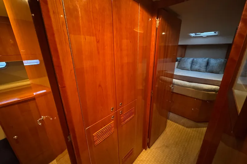 Slide: The Image of Luxurious interior of 2009 Riviera 45 Open Flybridge yacht with wood finishes and cozy bedroom. - 47