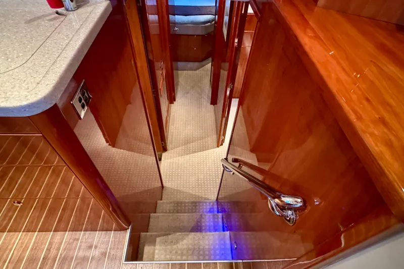 Slide: The Image of Interior view of 2009 Riviera 45 Open Flybridge yacht, featuring polished wood and carpeted stairs. - 41