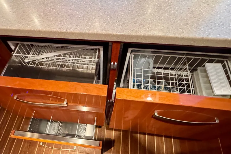 Slide: The Image of Wooden kitchen drawers with built-in appliances on a 2009 Riviera 45 Open Flybridge yacht. - 38
