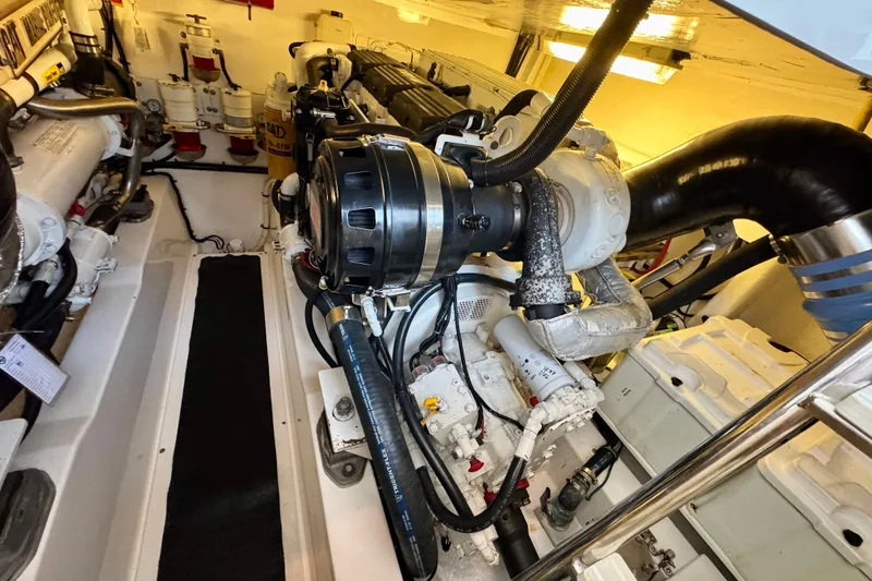Slide: The Image of Engine room of a 2009 Riviera 45 Open Flybridge yacht, showcasing mechanical components. - 57
