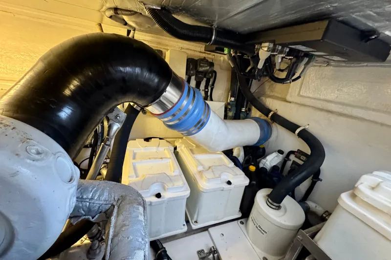 Slide: The Image of Engine room of 2009 Riviera 45 Open Flybridge with visible pipes and components. - 66