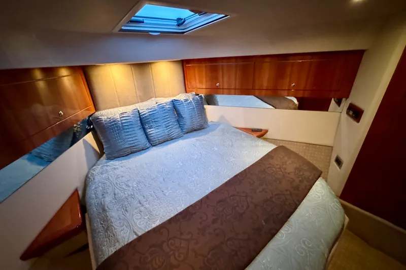 Slide: The Image of Luxurious bedroom interior of 2009 Riviera 45 Open Flybridge yacht with elegant bedding and wood accents. - 50