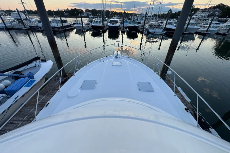 Slide: The Image of 2009 Riviera 45 Open Flybridge yacht docked at marina during sunset. - 25