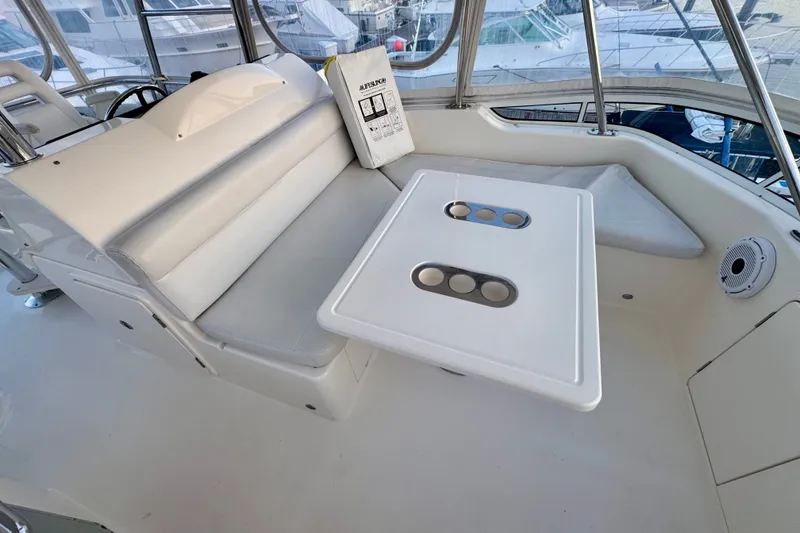 Slide: The Image of 2009 Riviera 45 Open Flybridge interior with seating and table, showcasing luxury yacht design. - 19