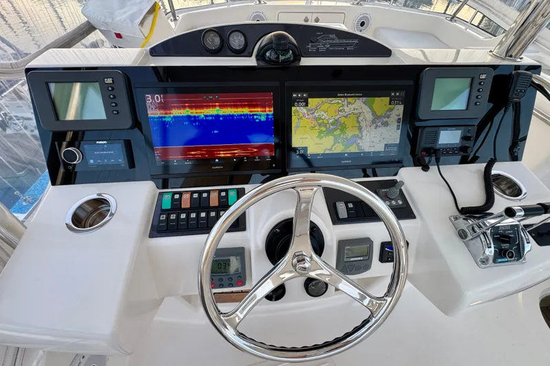 Slide: The Image of Control panel of a 2009 Riviera 45 Open Flybridge with navigation screens and steering wheel. - 22