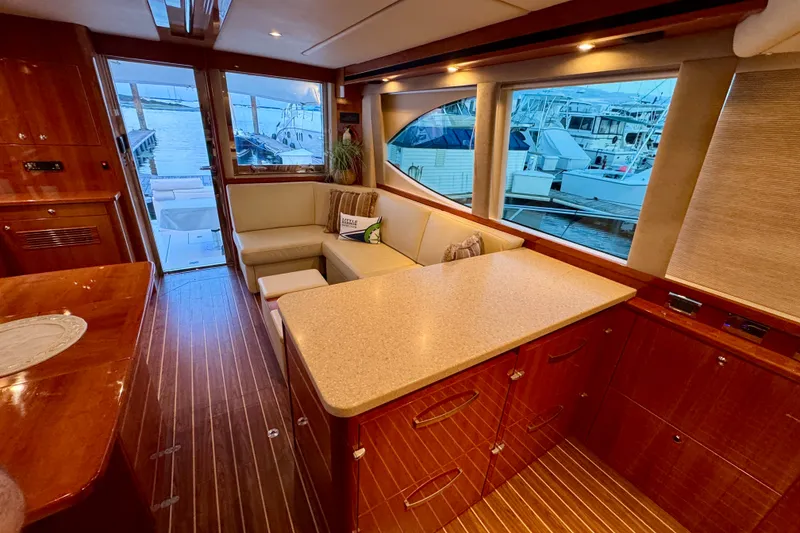 Slide: The Image of Luxurious interior of 2009 Riviera 45 Open Flybridge yacht with elegant wood finishes and marina view. - 33