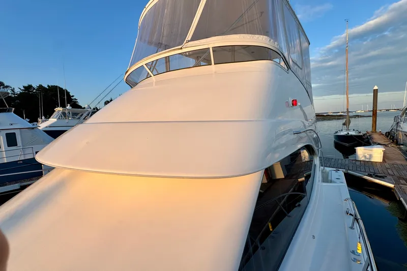 Slide: The Image of 2009 Riviera 45 Open Flybridge yacht docked at marina during sunset. - 12