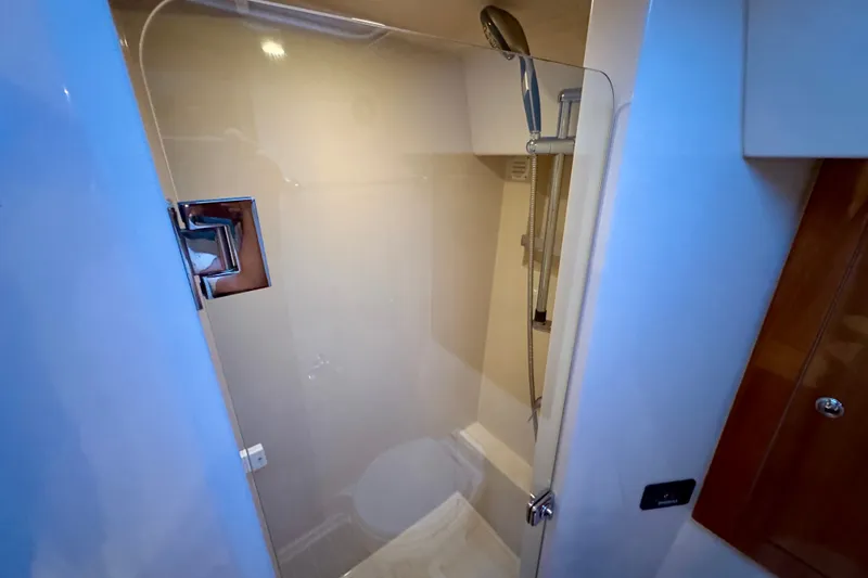 Slide: The Image of Shower area in 2009 Riviera 45 Open Flybridge yacht, featuring modern fixtures and glass door. - 55