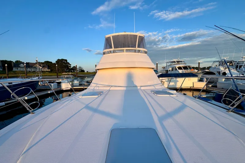 Slide: The Image of 2009 Riviera 45 Open Flybridge yacht docked at marina during sunset. - 11