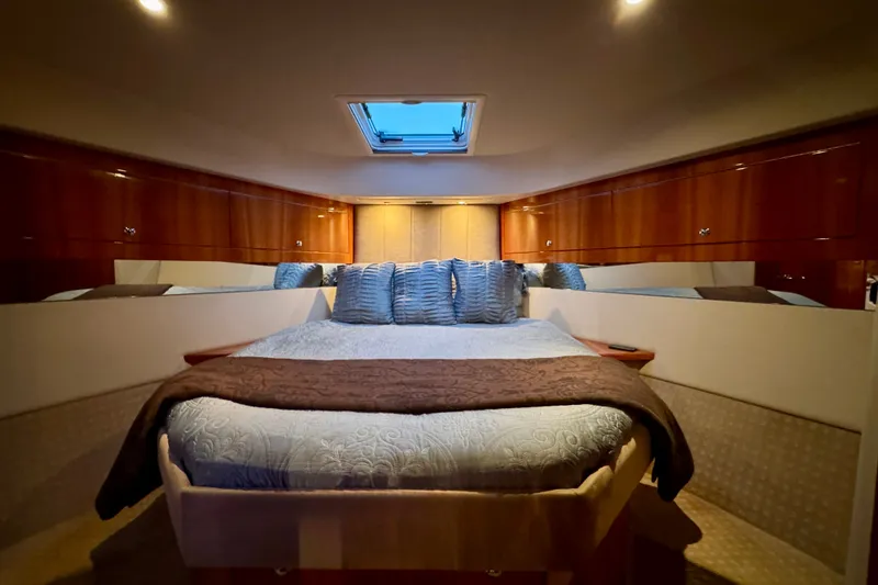 Slide: The Image of Luxurious bedroom interior of 2009 Riviera 45 Open Flybridge yacht with skylight and wood cabinetry. - 49