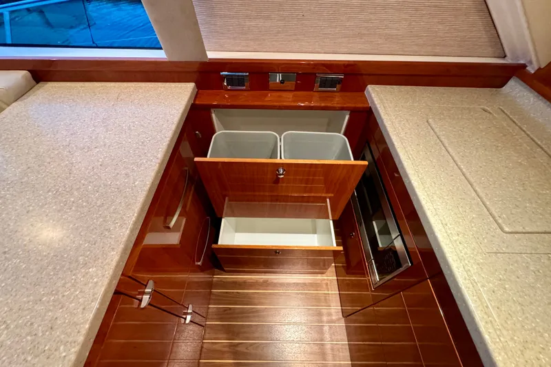 Slide: The Image of Interior of 2009 Riviera 45 Open Flybridge yacht kitchen with open cabinets and bins. - 39