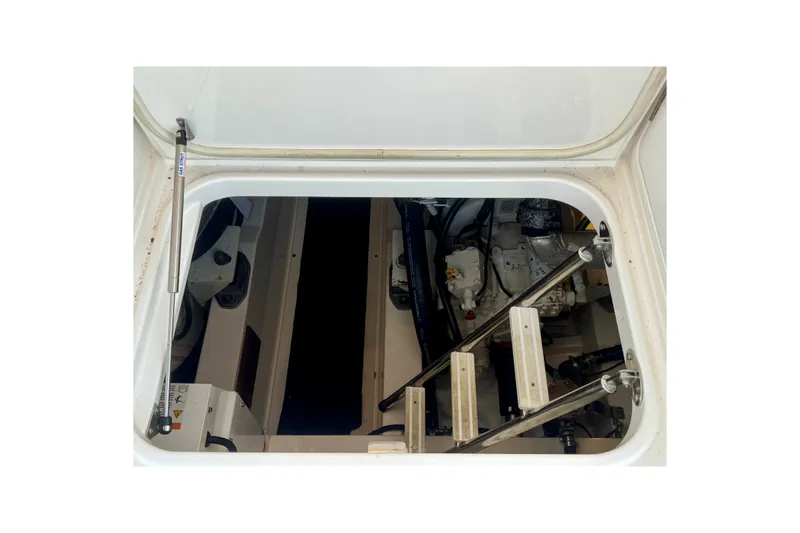 Slide: The Image of Engine compartment of 2009 Riviera 45 Open Flybridge with visible ladder and mechanical components. - 56