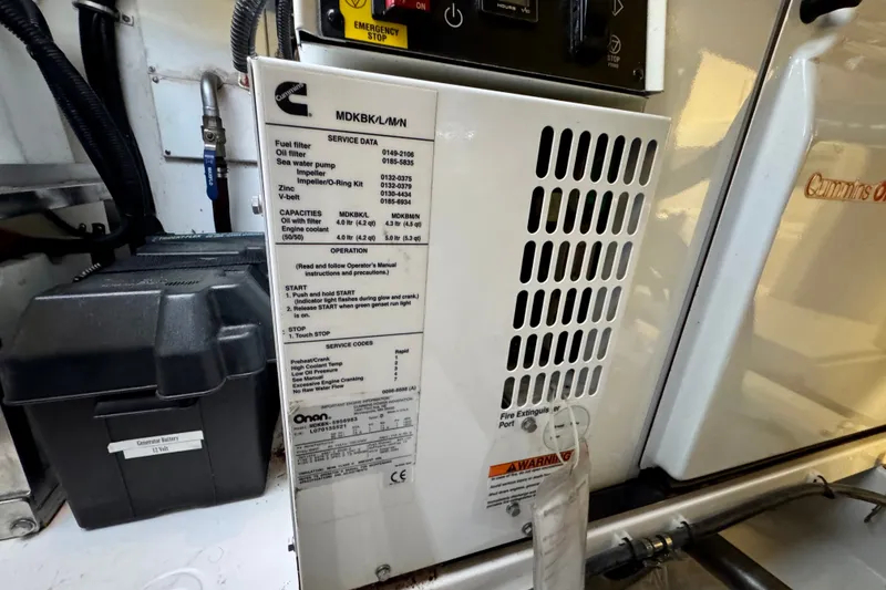 Slide: The Image of Engine compartment of 2009 Riviera 45 Open Flybridge with Cummins Onan generator details. - 63