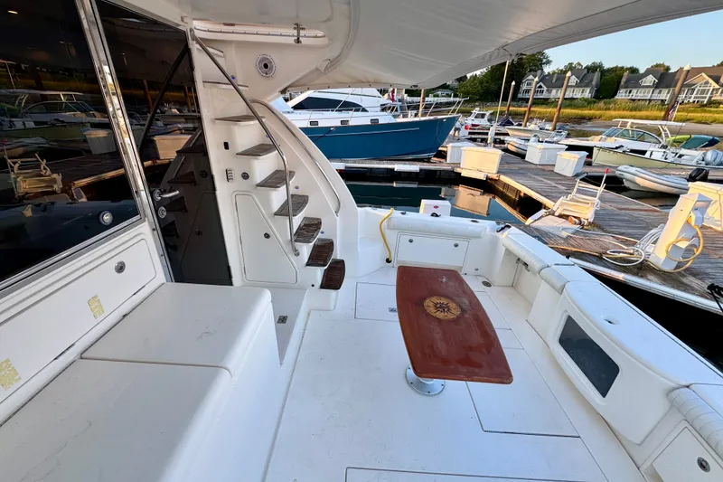 Slide: The Image of 2009 Riviera 45 Open Flybridge yacht interior with docked boats in marina background. - 14
