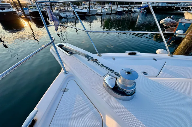 Slide: The Image of Bow of 2009 Riviera 45 Open Flybridge yacht at marina during sunset. - 10