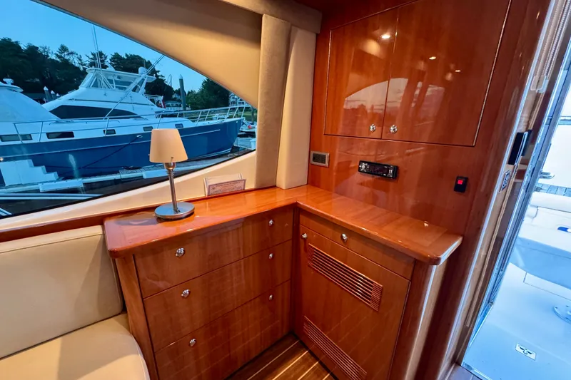 Slide: The Image of Luxurious interior of 2009 Riviera 45 Open Flybridge yacht with wooden cabinetry and lamp. - 29