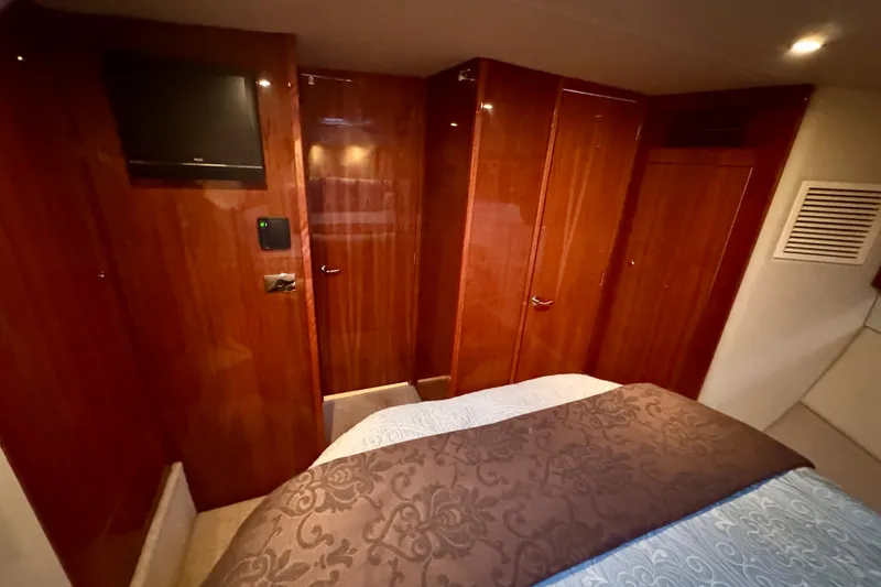 Slide: The Image of Luxurious interior of 2009 Riviera 45 Open Flybridge yacht with wood paneling and TV. - 52