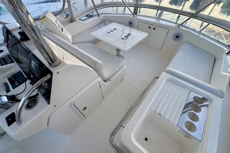 Slide: The Image of 2009 Riviera 45 Open Flybridge interior with seating, table, and control panel. - 18