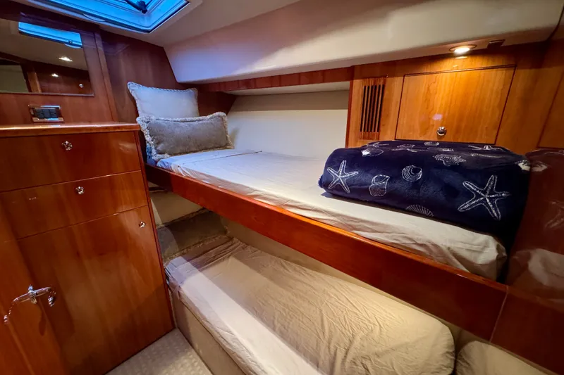 Slide: The Image of Interior of 2009 Riviera 45 Open Flybridge with cozy wooden bunk beds and nautical decor. - 43