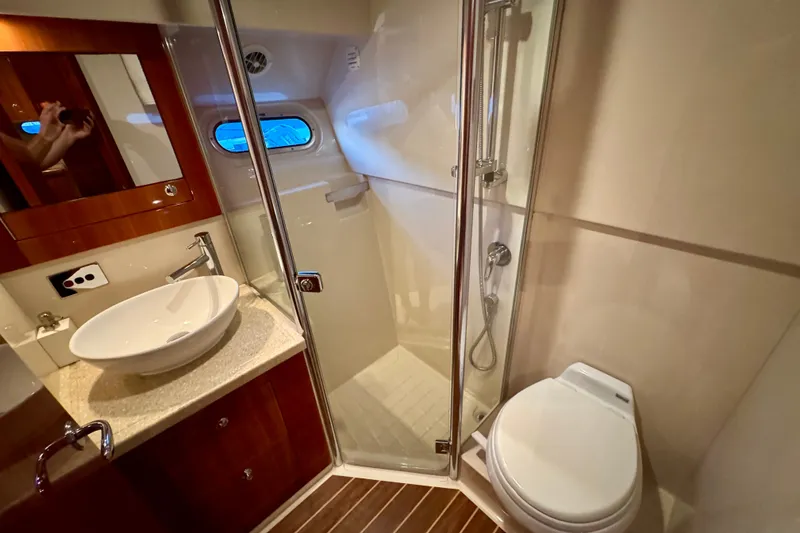 Slide: The Image of Luxurious bathroom in 2009 Riviera 45 Open Flybridge yacht with shower, sink, and toilet. - 44