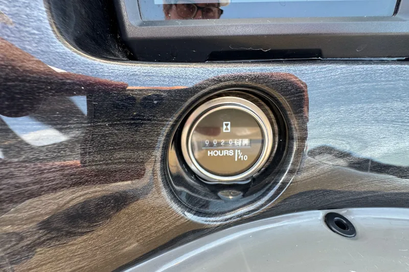Slide: The Image of Hour meter on 2023 Qwest Lanai 820 boat dashboard, displaying 20.8 hours. - 12
