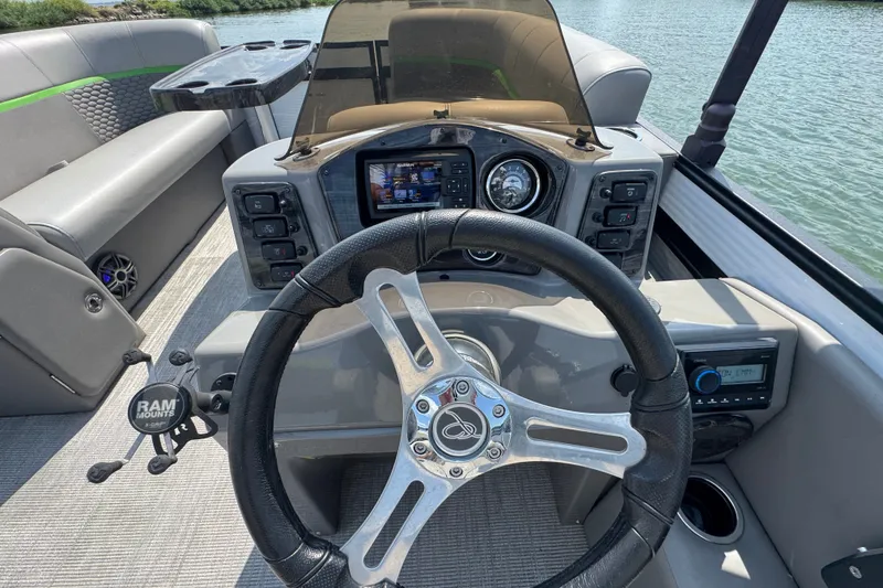 Slide: The Image of Steering console of 2023 Qwest Lanai 820 pontoon boat with modern controls and dashboard. - 10
