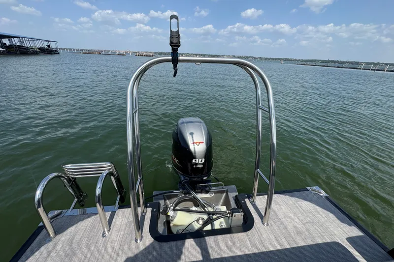 Slide: The Image of 2023 Qwest Lanai 820 pontoon boat with Yamaha 90 engine on a sunny lake. - 17