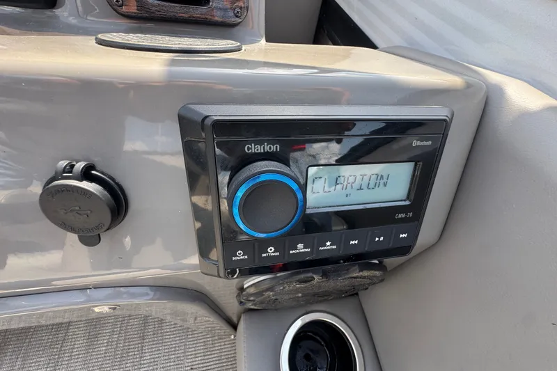 Slide: The Image of Clarion audio system in 2023 Qwest Lanai 820 boat dashboard. - 13