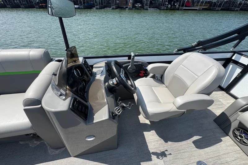 Slide: The Image of 2023 Qwest Lanai 820 boat interior with steering console and comfortable seating. - 9