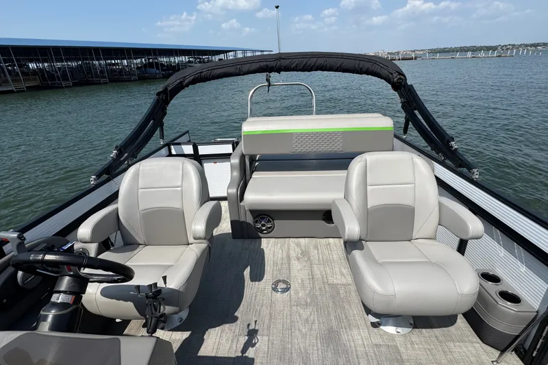 Slide: The Image of 2023 Qwest Lanai 820 pontoon boat interior with plush seating on a sunny day. - 8