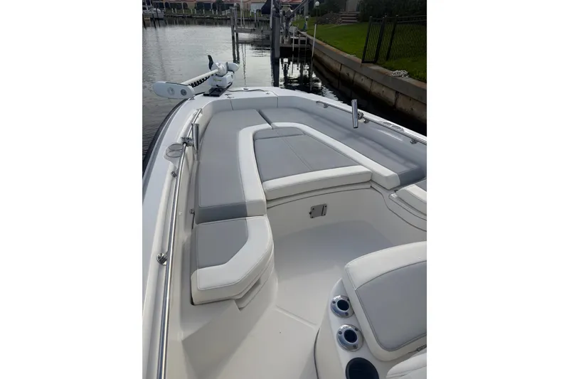 Slide: The Image of 2016 Boston Whaler 240 Dauntless boat interior with cushioned seating and cup holders. - 4