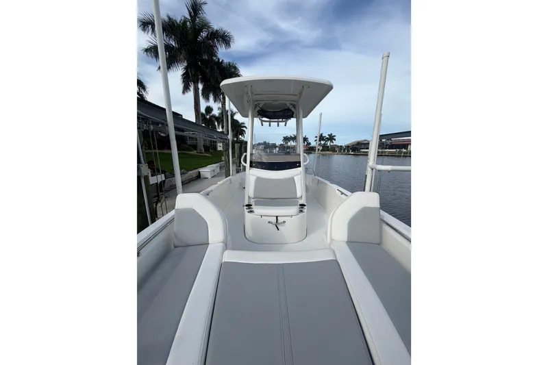 Slide: The Image of 2016 Boston Whaler 240 Dauntless boat interior with seating, dockside view. - 9