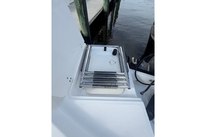 Slide: The Image of 2016 Boston Whaler 240 Dauntless boat ladder and deck detail by the water. - 26