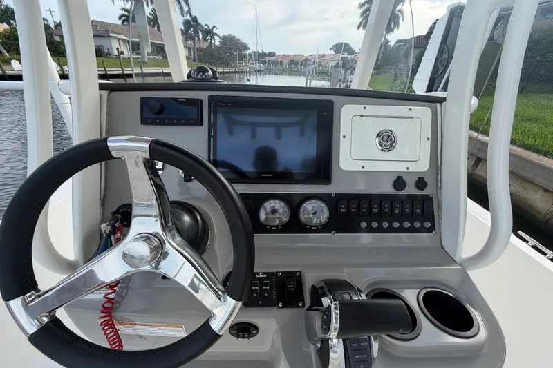 Slide: The Image of Steering console of a 2016 Boston Whaler 240 Dauntless boat with navigation controls. - 18