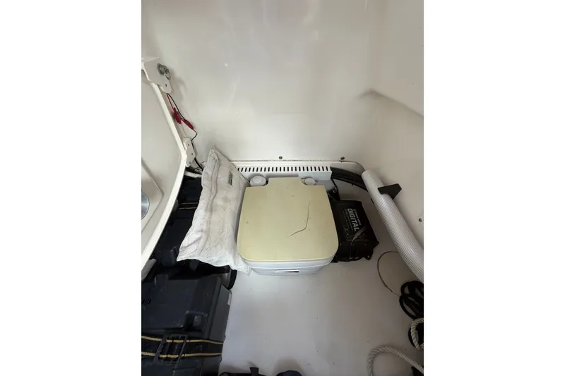 Slide: The Image of Interior of a 2016 Boston Whaler 240 Dauntless boat, featuring storage and equipment. - 16