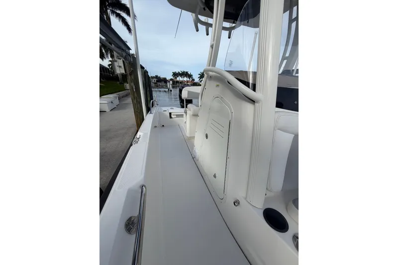 Slide: The Image of 2016 Boston Whaler 240 Dauntless boat deck with sleek design and waterfront view. - 13