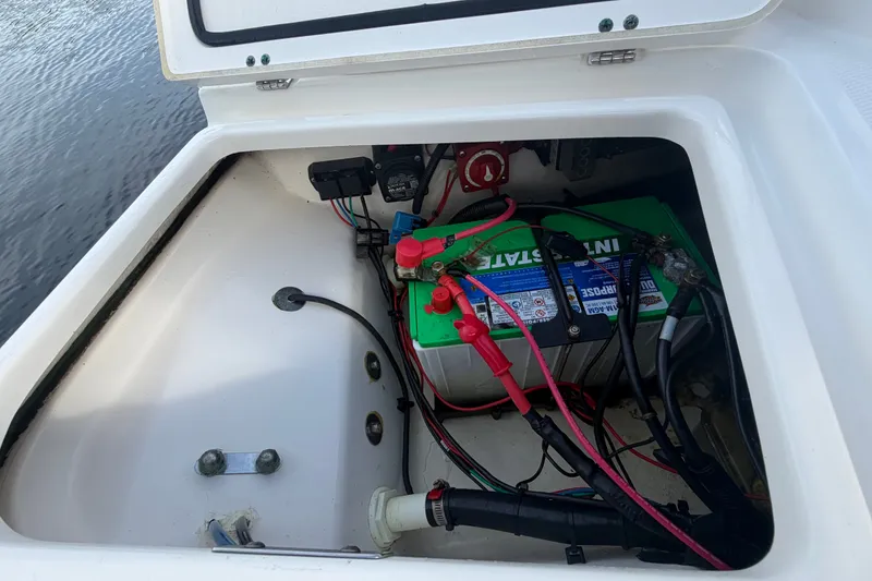 Slide: The Image of Battery compartment of a 2016 Boston Whaler 240 Dauntless boat, showing wiring and connections. - 27