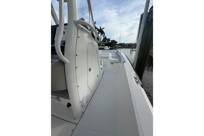 Slide: The Image of Boston Whaler 240 Dauntless 2016 boat docked, showcasing sleek deck and console design. - 15