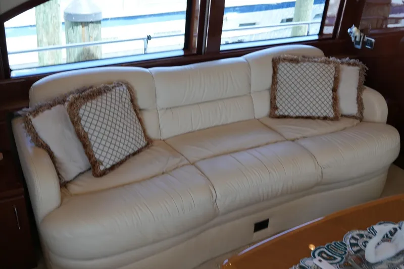 Slide: The Image of Luxurious white leather sofa with decorative pillows on a 2008 Marquis 65 Skylounge yacht. - 14