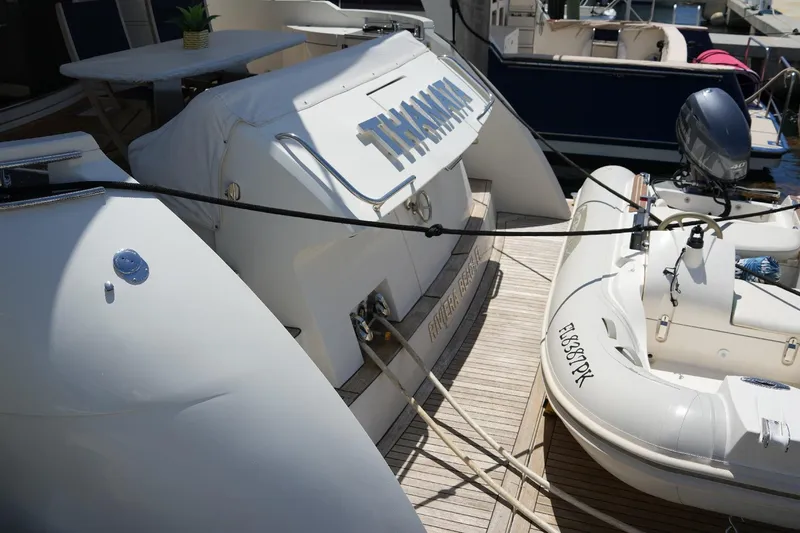 Slide: The Image of 2008 Marquis 65 Skylounge yacht with attached inflatable boat at marina dock. - 5