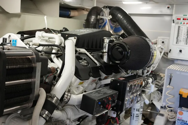 Slide: The Image of Engine room of a 2008 Marquis 65 Skylounge yacht, showcasing intricate machinery and components. - 73