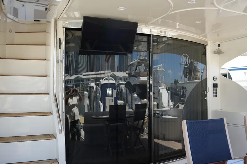 Slide: The Image of 2008 Marquis 65 Skylounge yacht interior with stairs, glass doors, and marina view. - 20