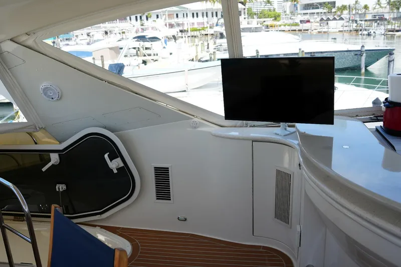 Slide: The Image of Interior of 2008 Marquis 65 Skylounge yacht with TV and marina view. - 38